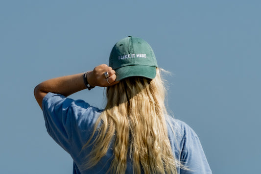 Woman wearing an East Coasting hat in teal green.