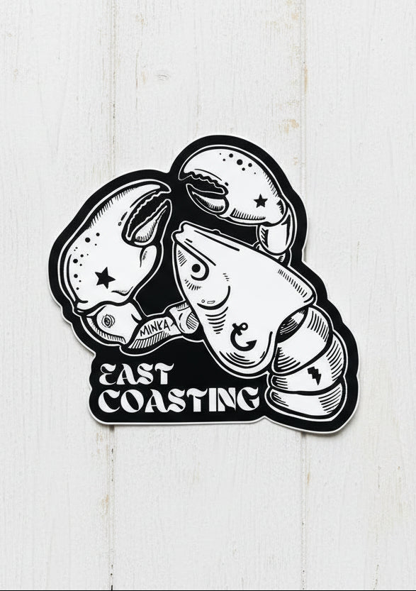 Sticker with lobster design and 'East Coasting' text on a wooden surface