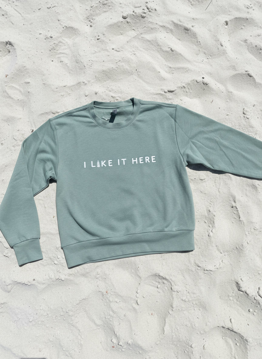 Green long-sleeve shirt with text on a textured surface