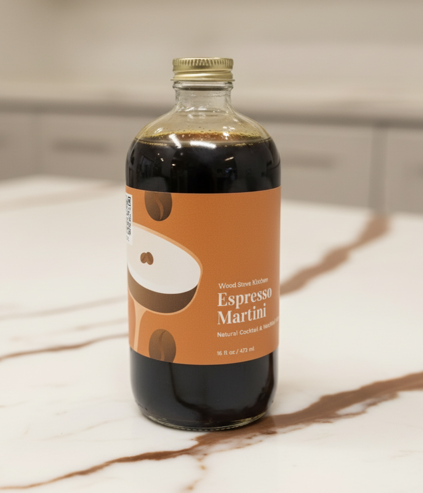 A bottle of Espresso Martini Mixer with a white and brown label, 16 oz size, on a white background.