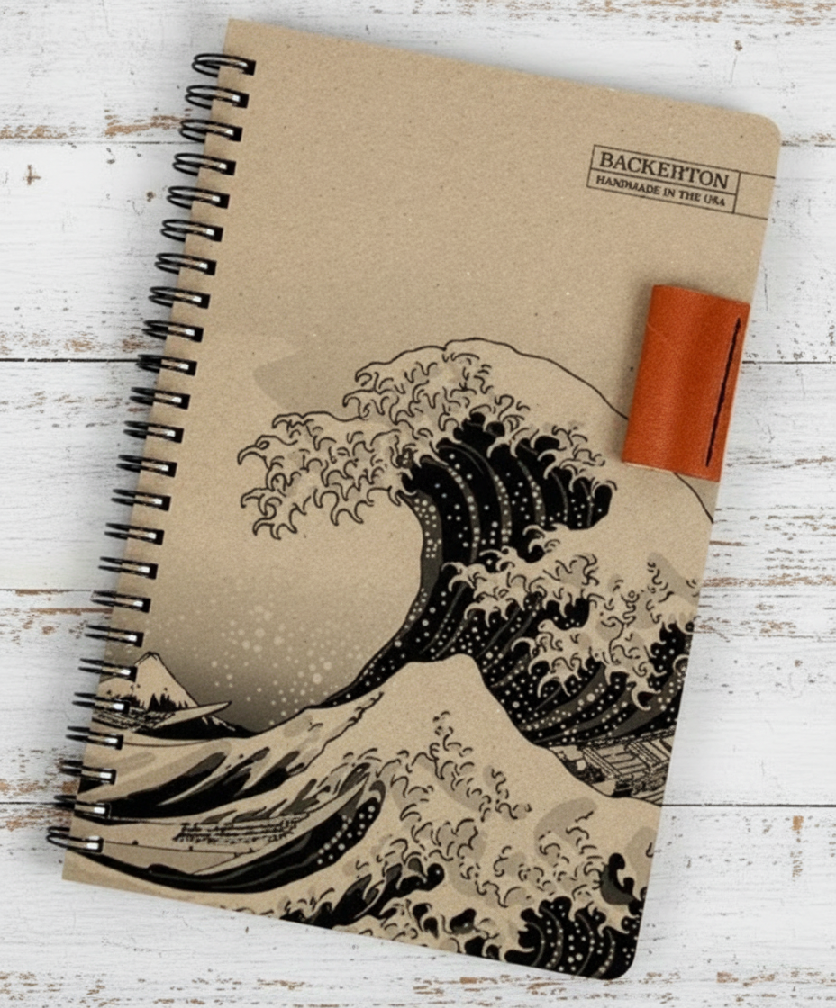 Notebook with wave design on a wooden surface