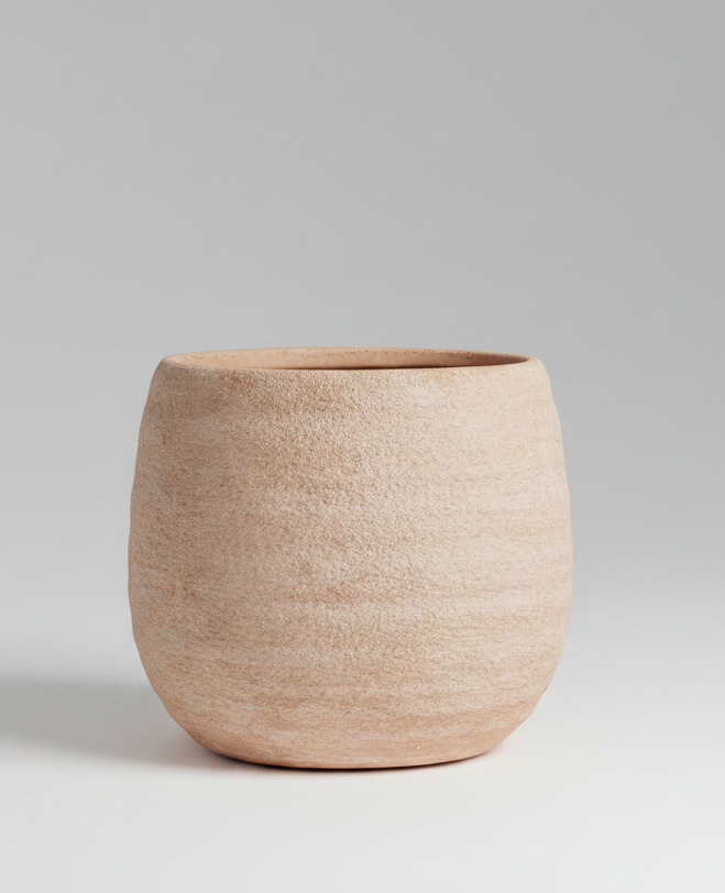 Beige ceramic pot on a white background