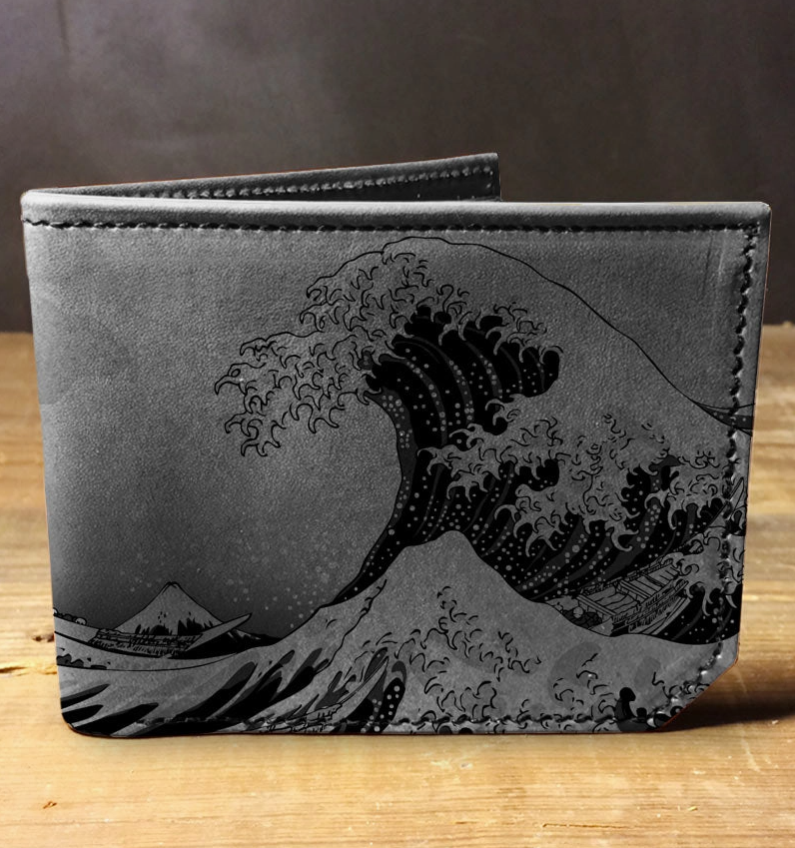 Gray wallet with wave design on a wooden surface