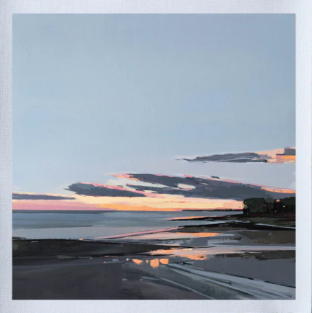 Sunset over a beach with reflected colors on the water