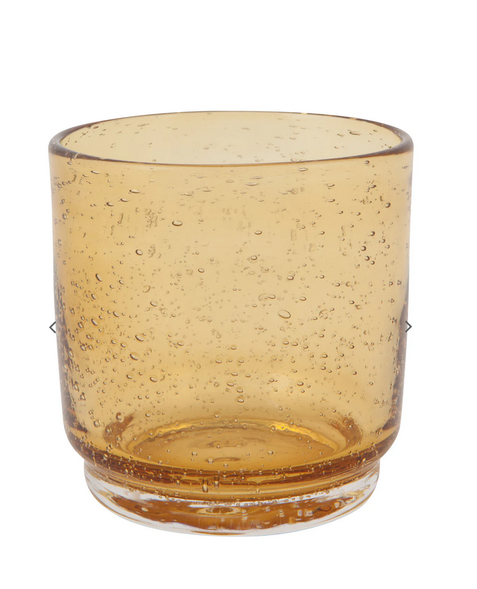 A beige glass tumbler with a bubble pattern.