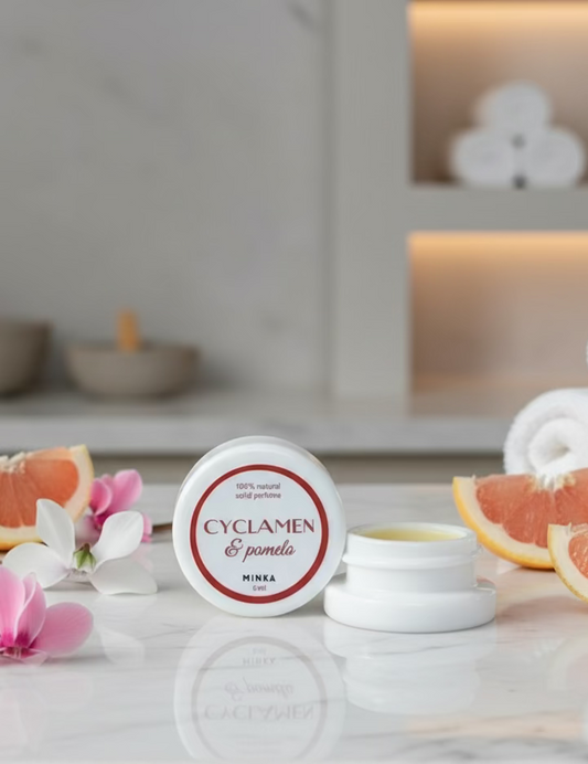 Small white container with a red label on a reflective surface