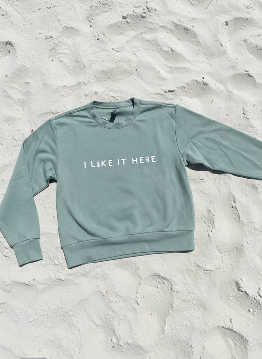 Green long-sleeve shirt with text on a textured surface