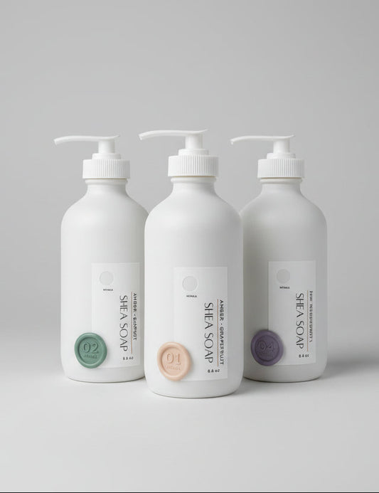 Three white bottles with pump dispensers on a gray background