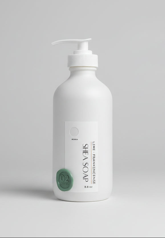 Shea soap bottle with pump on a wooden surface