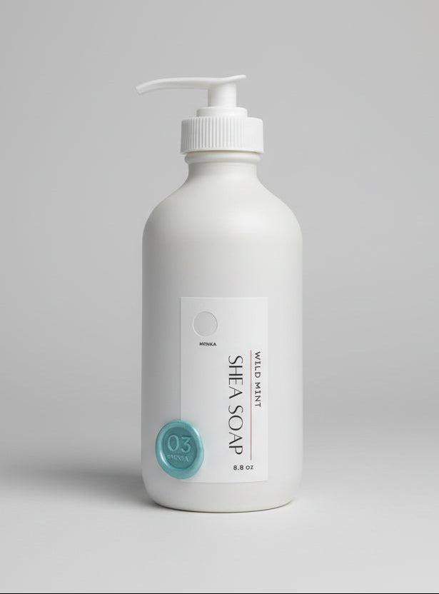 Shea soap bottle with pump on a wooden surface