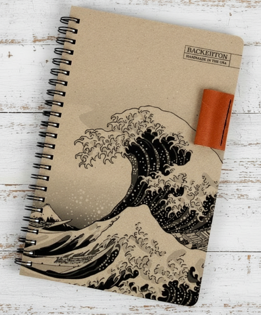 Notebook with wave design on a wooden surface