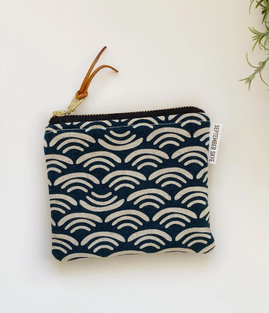 Navy blue pouch with wave pattern on a white background