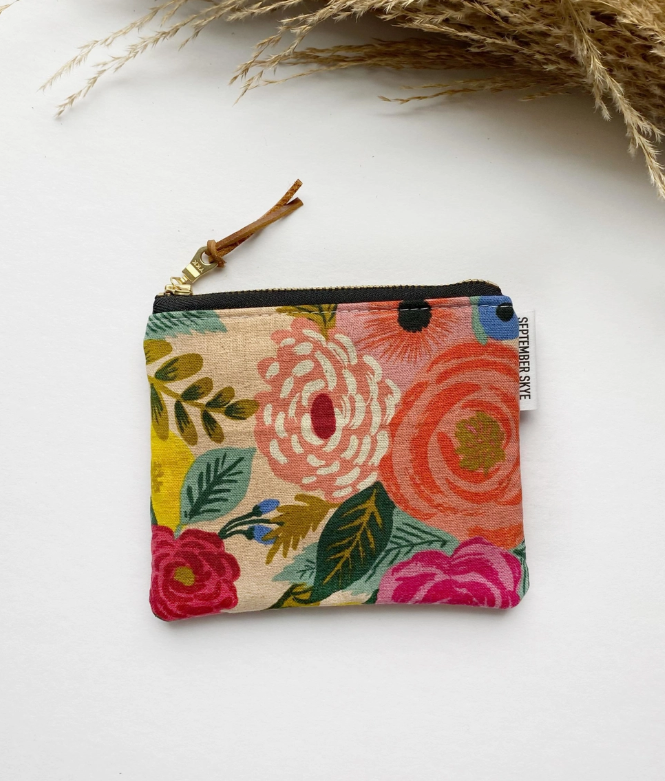 Floral patterned pouch with a zipper on a white background
