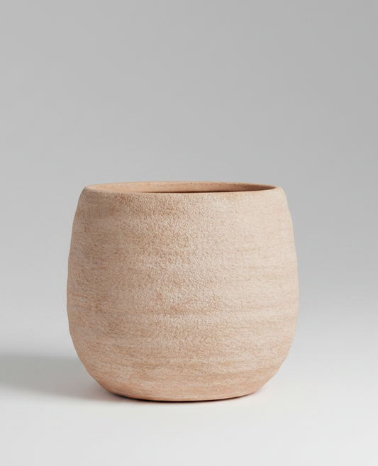 Beige ceramic pot on a white background