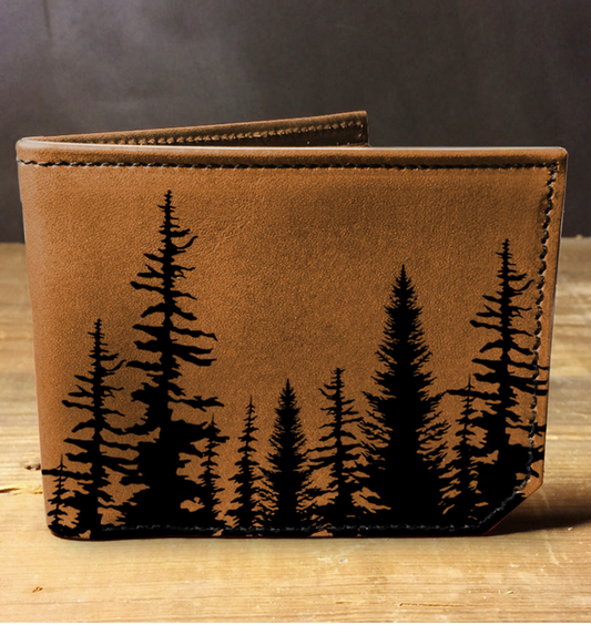 Brown leather wallet with black tree pattern on a wooden surface