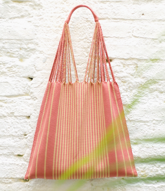 Striped fabric bag with a handle on a textured white background