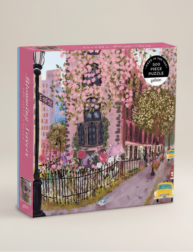 Puzzle box with a colorful illustration of a street scene with cherry blossoms and a building.
