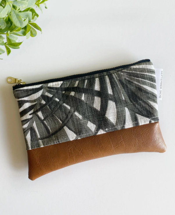 Pouch with leaf pattern and brown accent on a white background