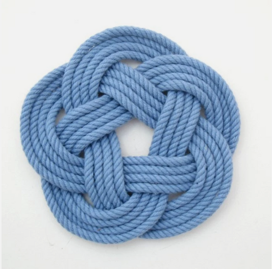 A light blue braided rope knot arranged in a circular medallion shape, photographed on a clean white background.
