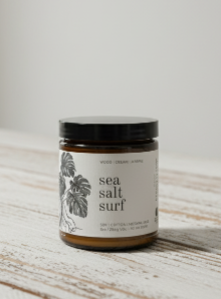 Jar of 'sea salt surf' on a wooden surface with a light background
