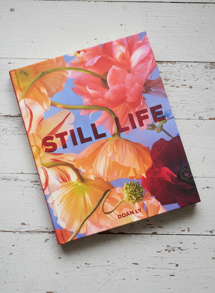 Book cover with floral design and 'STILL LIFE' text on a light background
