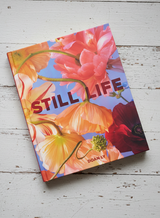 Book cover with floral design and 'STILL LIFE' text on a light background
