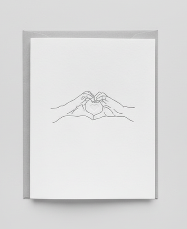 Framed line art of two hands holding each other on a white background