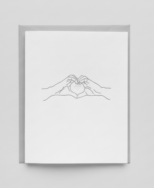Framed line art of two hands holding each other on a white background