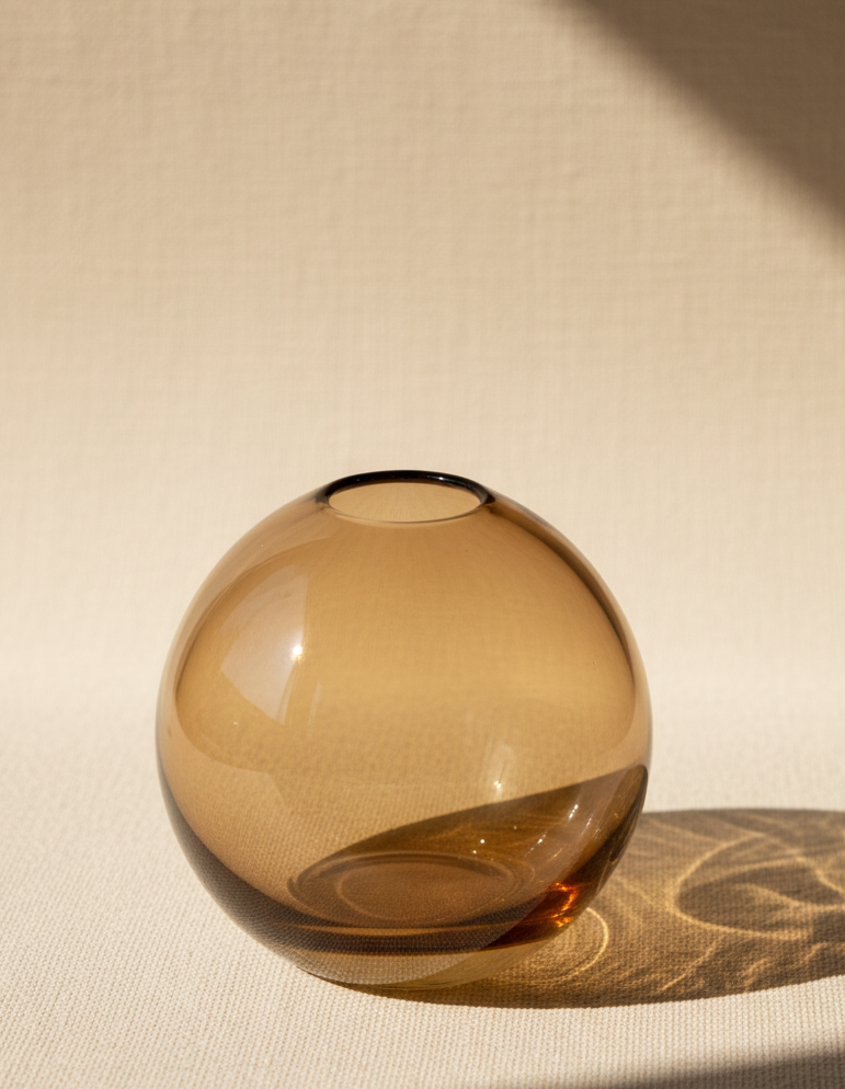 Brown glass vase on a white surface