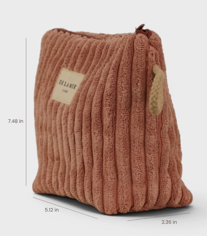 A ribbed corduroy cosmetic pouch in a dusty rose-brown color, shown with dimension lines indicating its measurements of 7.48 in height, 5.