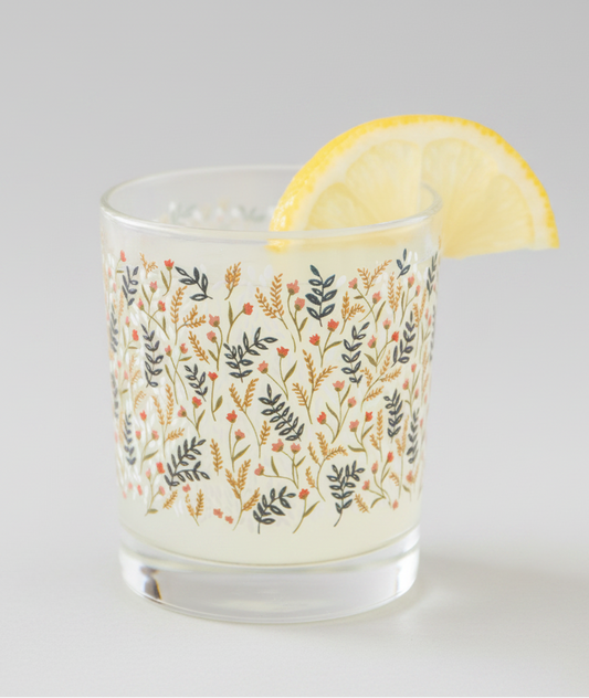 Decorative glass with floral pattern on a blurred natural background